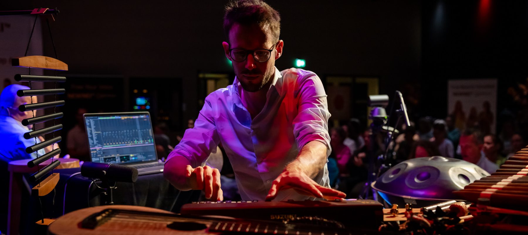 Raphael Bexx performing live, surrounded by his instruments